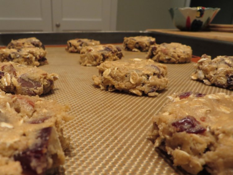 flattened balls of dough for chocolate-pecan oatmeal cookies with cherries