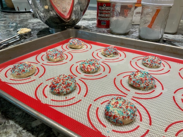 Sugar cookie dough portioned onto baking sheet