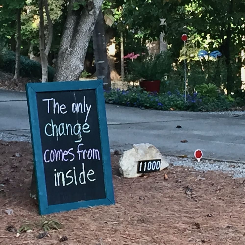 Chalkboard in yard with encouraging message