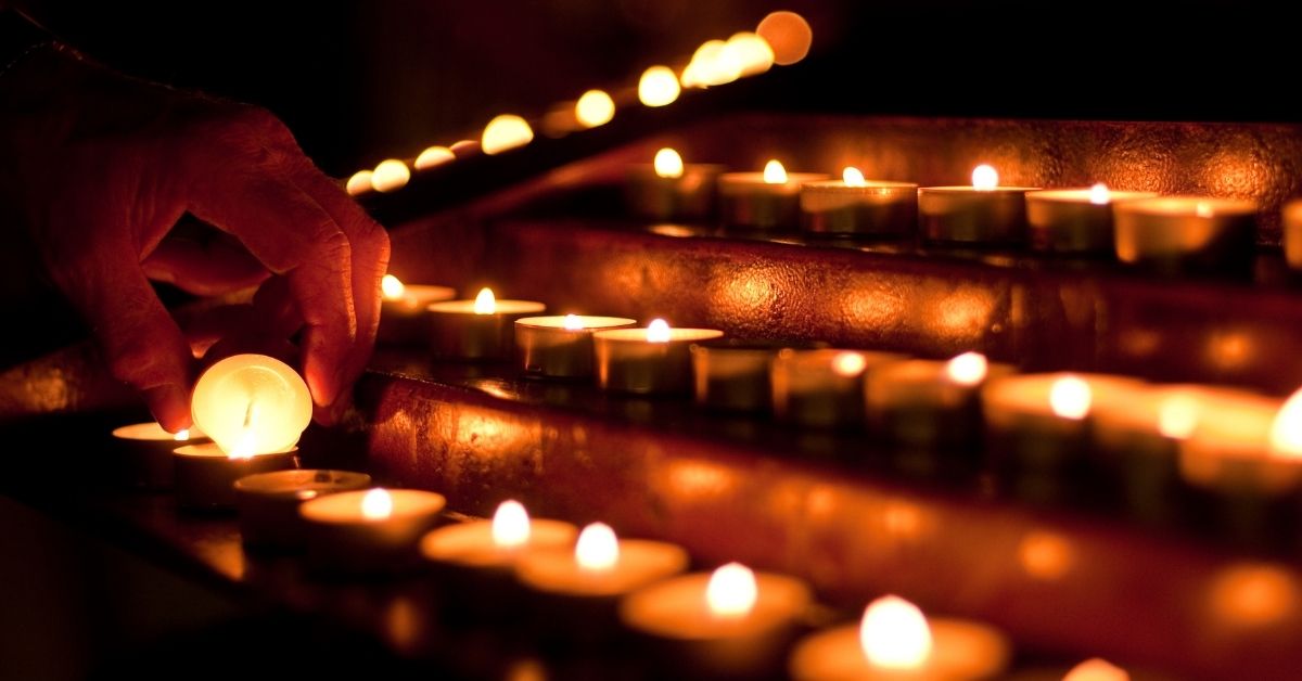 Devotional Candles lit in a Church illustrating power of small acts of service