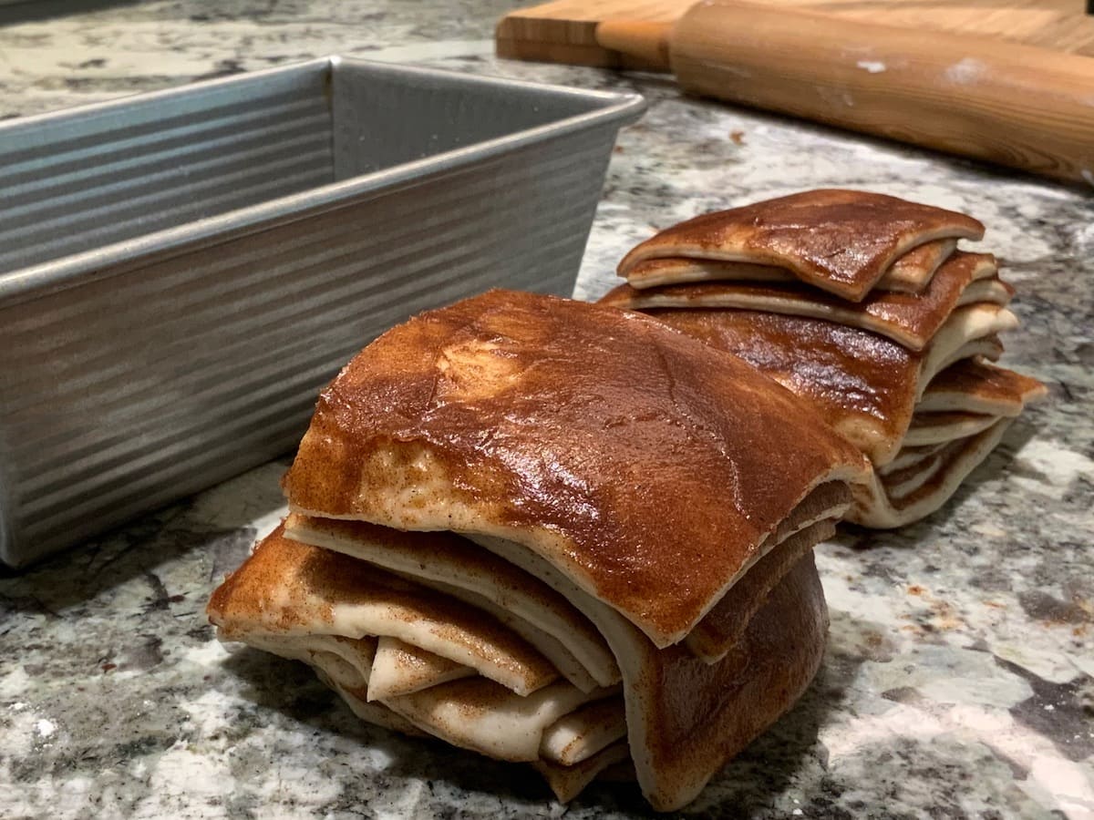 Stacks of dough squares for Cinnamon Pull-Apart Bread